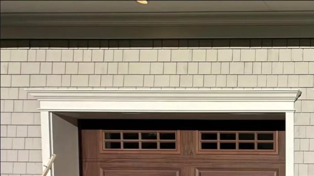Wood-grain raised-panel garage door with upper windows
