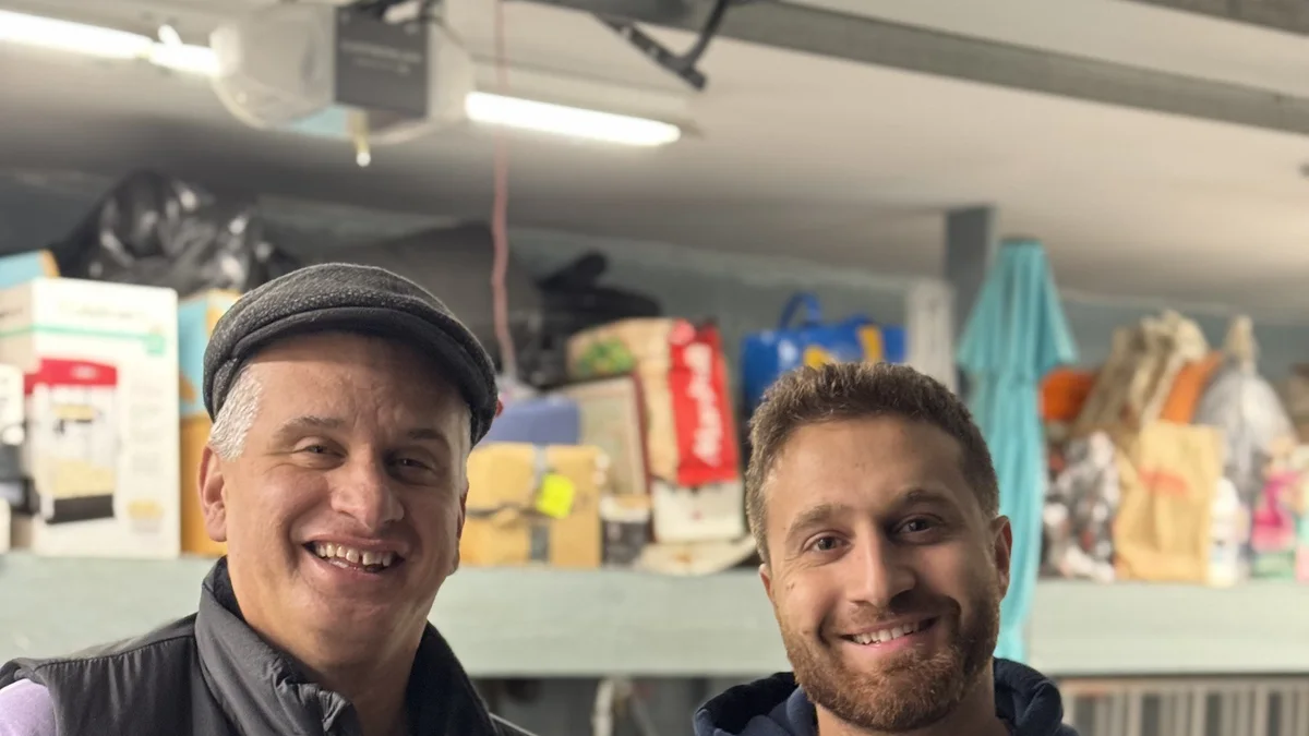 Two people standing together inside a garage after a service visit