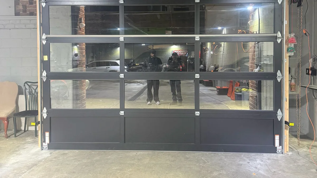 Glass-panel sectional garage door inside a commercial building