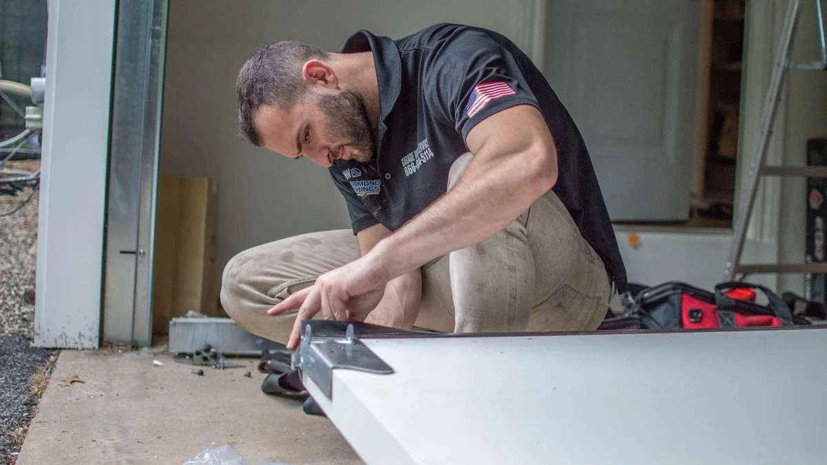 Technician working on a door panel with hand tools