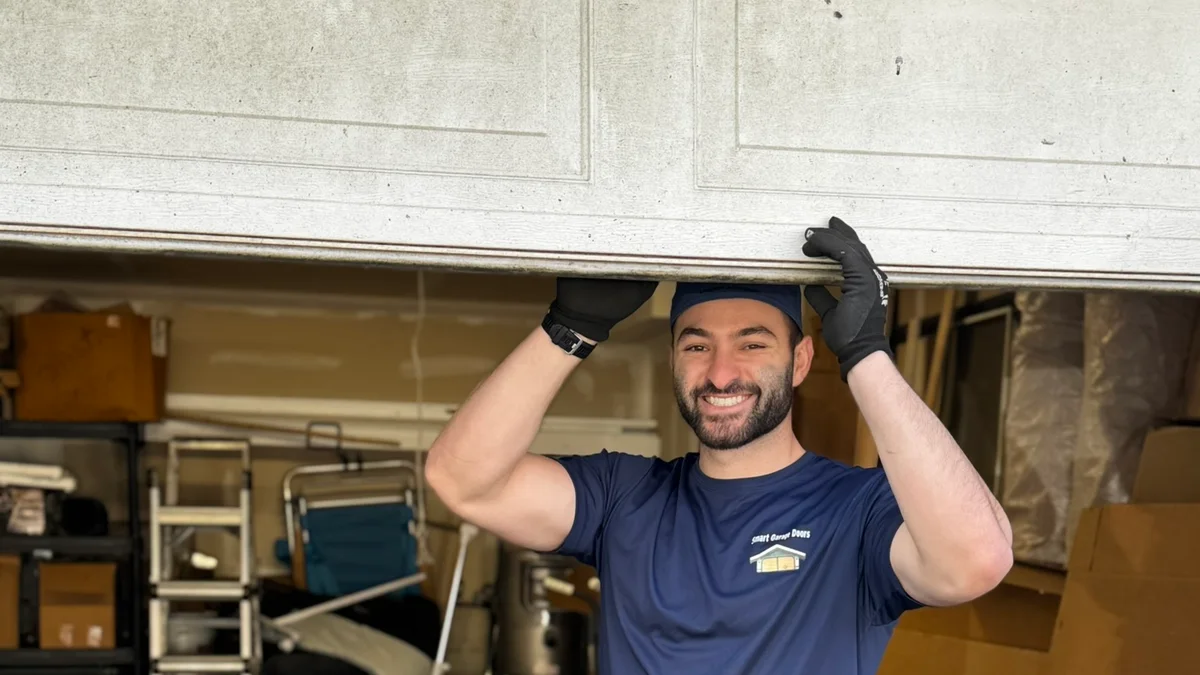 Garage door technician standing inside a residential garage