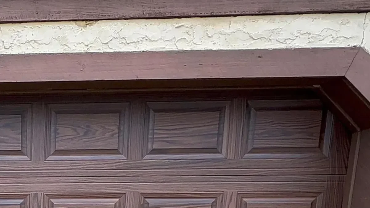 Mahogany wood-grain garage door with raised panels