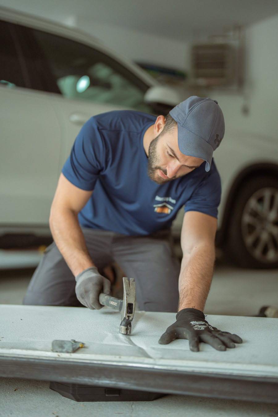 Smart Garage Doors technician working on garage door panel
