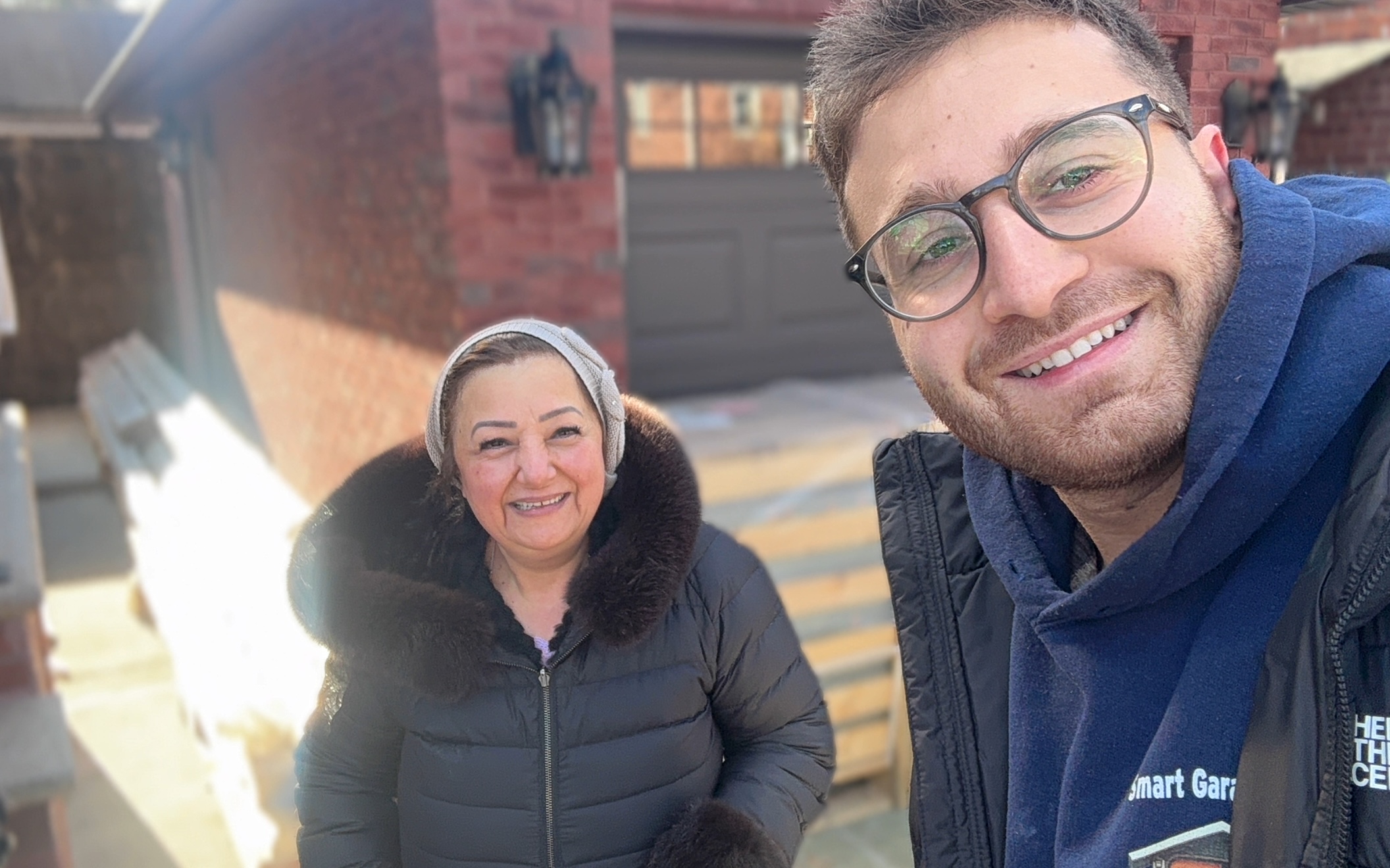 Happy homeowner with Smart Garage Doors technician after installation