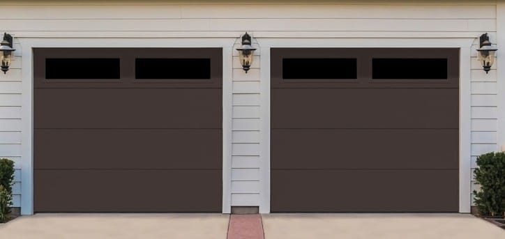Sectional garage door installation — raised panel double door on residential home